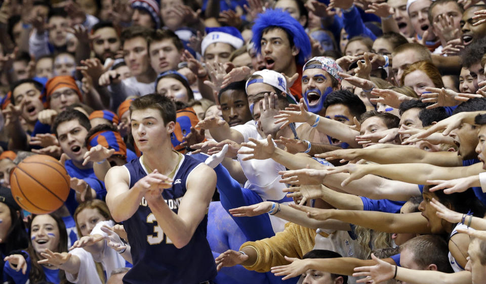 FILE - Duke fans cheer as Notre Dame's Steve Vasturia inbounds the ball during the first half of an NCAA college basketball game in Durham, N.C., Saturday, Feb. 7, 2015. Stopping fans from storming the courts or fields has always been a challenge for schools after big wins and upsets. But heading into March Madness, recent incidents have shed the light on the basketball court, where students especially typically sit close to the court and can get amid the teams quickly. (AP Photo/Gerry Broome, File)