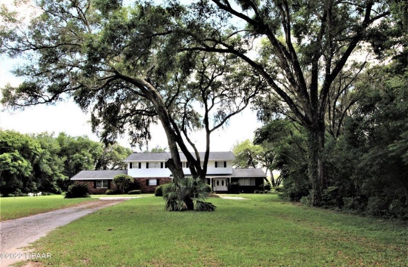 A long driveway surrounded by large oaks leads to this country estate in Pierson that was custom built to make the most of its lakefront setting.