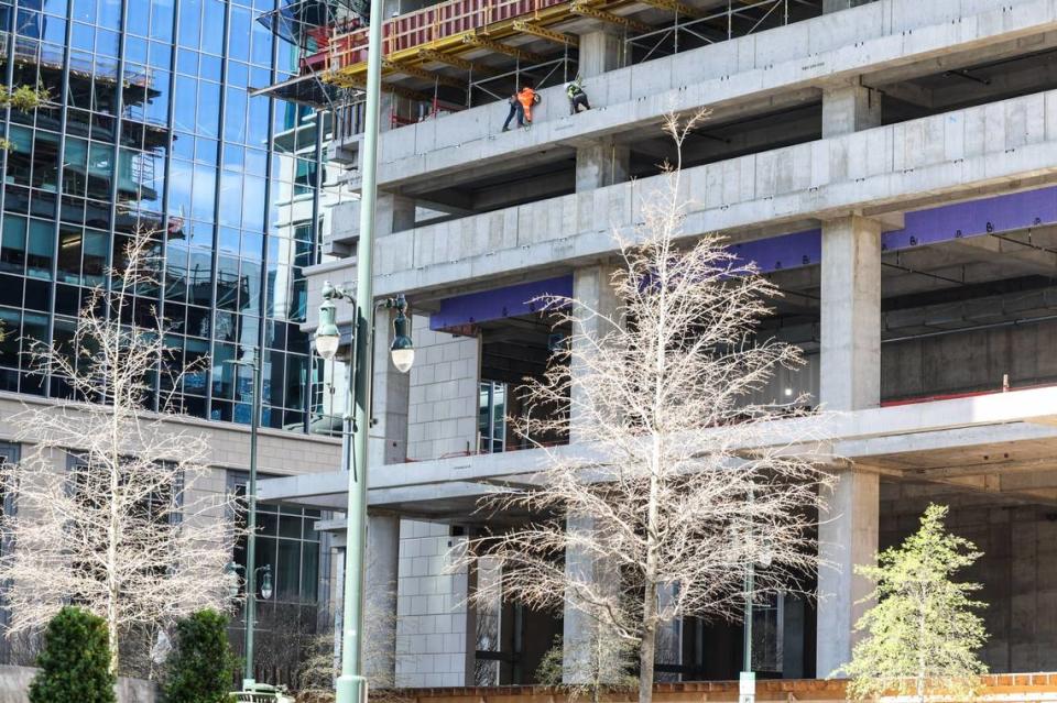 Workers at an office tower under construction in uptown Charlotte.