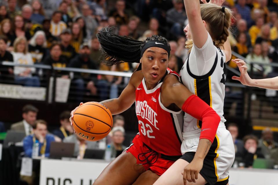 Ohio State forward Cotie McMahon (32) works around Iowa guard Kate Martin, right, in the first half of an NCAA college basketball championship game at the Big Ten women's tournament, Sunday, March 5, 2023, in Minneapolis. Iowa won 105-72. (AP Photo/Bruce Kluckhohn)