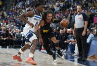 Denver Nuggets forward Aaron Gordon, second from left, drives past Minnesota Timberwolves guard Anthony Edwards, left, in the first half of Game 2 of an NBA basketball second-round playoff series Monday, May 6, 2024, in Denver. (AP Photo/David Zalubowski)