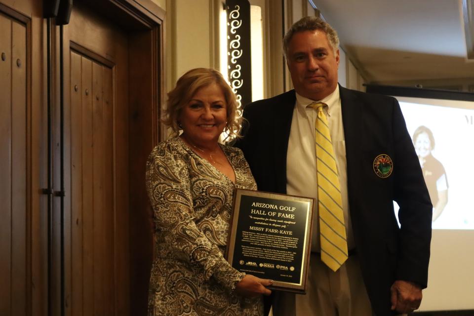 Arizona State Missy Farr-Kaye holds a plaque alongside Arizona Golf Hall of Fame Chair Drew Woods after she was inducted into the 2022 Arizona Sports Hall of Fame at the Paradise Valley Country Club on Oct. 25, 2022.