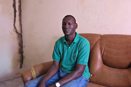 Mamadou Ka poses for a picture in his family home after being repatriated last month from Gabon, in Dakar, Senegal, September 2, 2015. REUTERS/Makini Brice