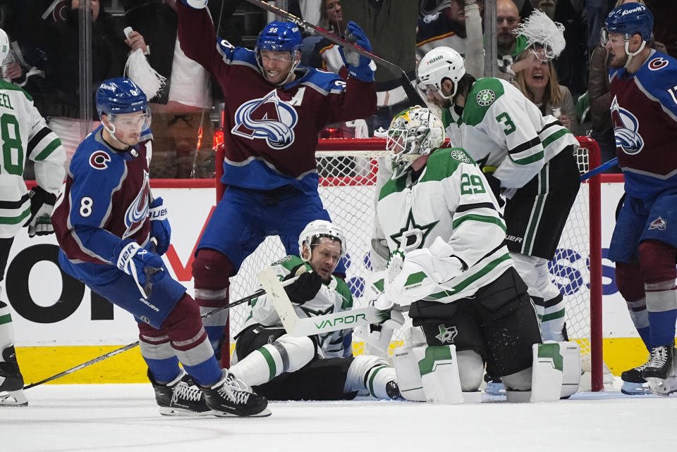 Colorado Avalanche right wing Mikko Rantanen, second from left, celebrates his goal against Dallas Stars goalie Joke Oettinger, as Avalanche defenseman Cale Makar, left, turns away from the goal during the second period of Game 3 of an NHL hockey Stanley Cup playoff series Saturday, May 11, 2024, in Denver. (AP Photo/David Zalubowski)