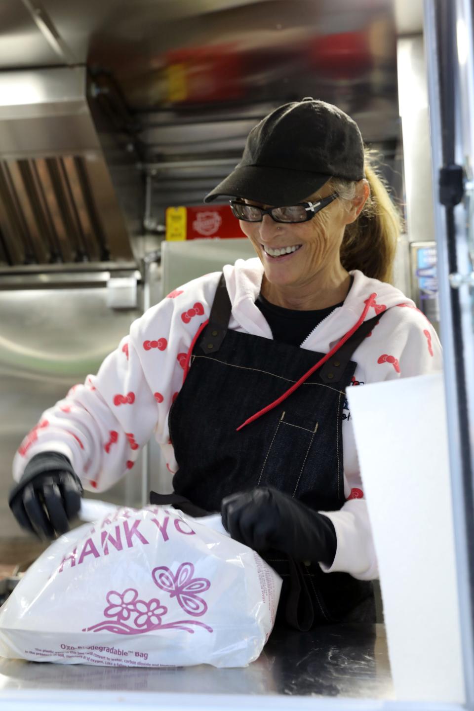 Executive Director Anna Kobelka packs meals on the new Helping Hands For the Homeless of Rockland food truck, while parked in Memorial Park in Spring Valley Dec. 28, 2023.