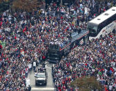 Fans cheer the 2021 World Series baseball champion Atlanta Braves during a victory parade in Atlanta, Friday, Nov. 5, 2021. (Curtis Compton/Atlanta Journal-Constitution via AP)