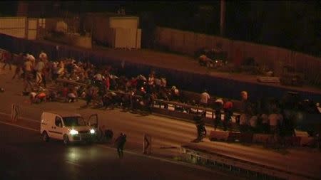 Still frame taken from video shows people running for cover from gunshots along the Bosphorus Bridge in Istanbul, during an attempted coup in Turkey, on July 15, 2016. REUTERS/REUTERS TV