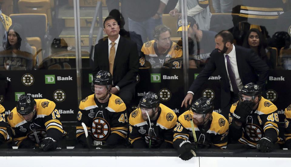 Boston Bruins head coach Bruce Cassidy checks the clock as time winds down during the third period in Game 7 of the NHL hockey Stanley Cup Final against the St. Louis Blues, Wednesday, June 12, 2019, in Boston. (AP Photo/Charles Krupa)