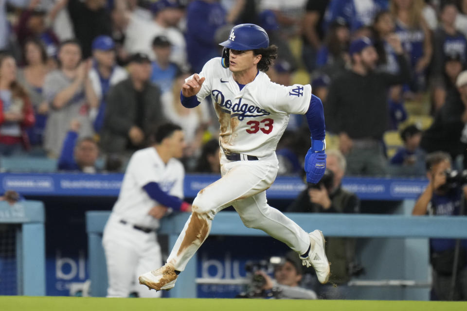 Los Angeles Dodgers' James Outman heads home to score on a double by Michael Busch during the fourth inning of the team's baseball game against the Houston Astros on Friday, June 23, 2023, in Los Angeles. (AP Photo/Jae C. Hong)