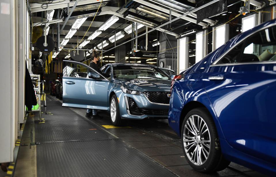 General Motors Co. employees work the line Tuesday, Jan. 31, 2023, at the Lansing Grand River Assembly Plant in Lansing.