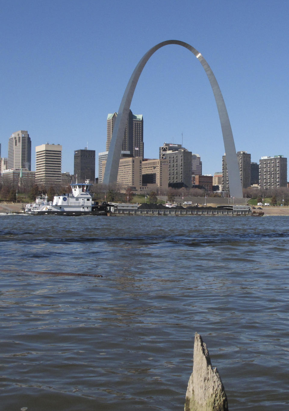 A barge heads north on the Mississippi River past St. Louis on Monday, Nov. 12, 2012, as seen from East St. Louis, Ill. Missouri Gov. Jay Nixon and the barge industry are pressing the federal government to take steps to keep enough water flowing on the drought-ridden Missouri and Mississippi rivers to avert a potential "economic disaster," given the Mississippi's importance as a commerce corridor. Winter typically is a low-water period on the two big rivers, but the situation is more dire this year with many points long the waterways at or near historic lows. (AP Photo/Jim Suhr)