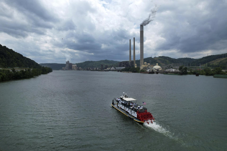 A riverboat carrying the Eucharist cruises down the Ohio River between Wellsburg, West Virginia, and Brilliant, Ohio, Sunday, June 23, 2024. The voyage is part of a two-month series of cross-country pilgrimages focused on the Eucharist, seeking to raise devotion around a sacrament in which Catholics believe they encounter Jesus' real presence. (AP Photo/Jessie Wardarski)