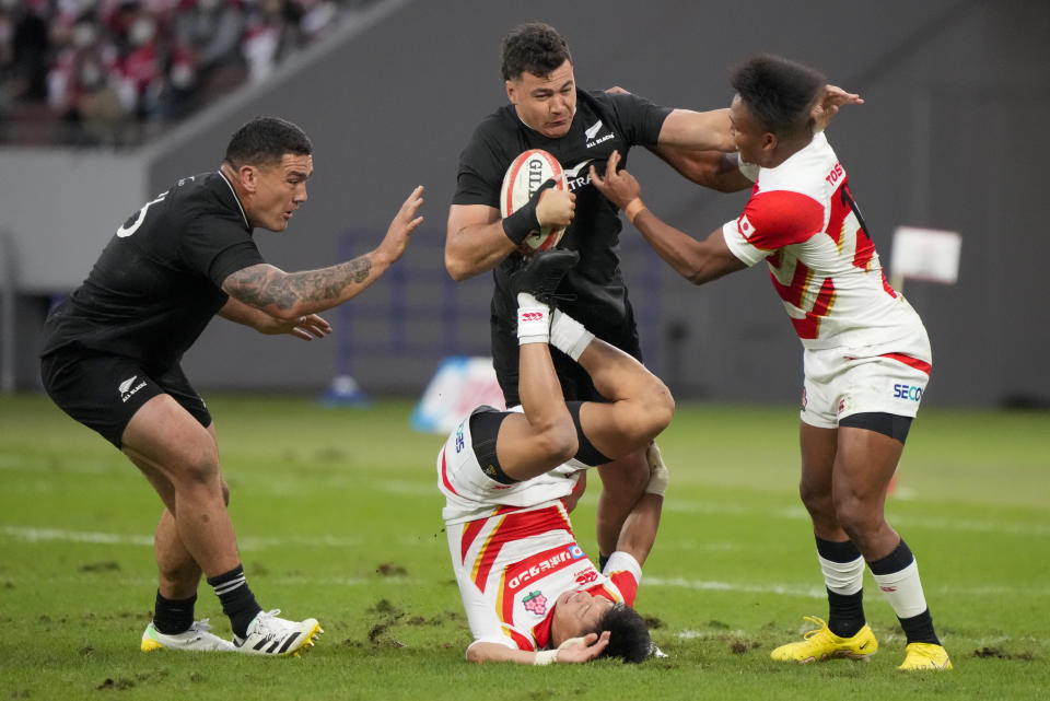 New Zealand's David Havili attempts to break a tackle during the rugby international between the All Blacks and Japan at the National Stadium in Tokyo, Japan, Saturday, Oct. 29, 2022. (AP Photo/Shuji Kajiyama)