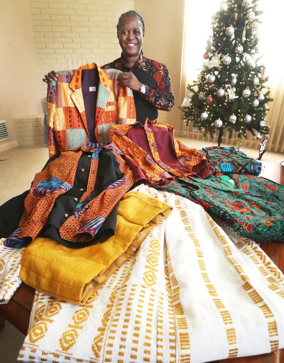 Daytona Beach native Maurice Gattis poses with some of the clothes from his Fort Mosé 1738 fashion line in his childhood home near where he went to school at Westide Elementary. The new company was formed in partnership with a West African couple that he met by chance on a vacation to Ghana.