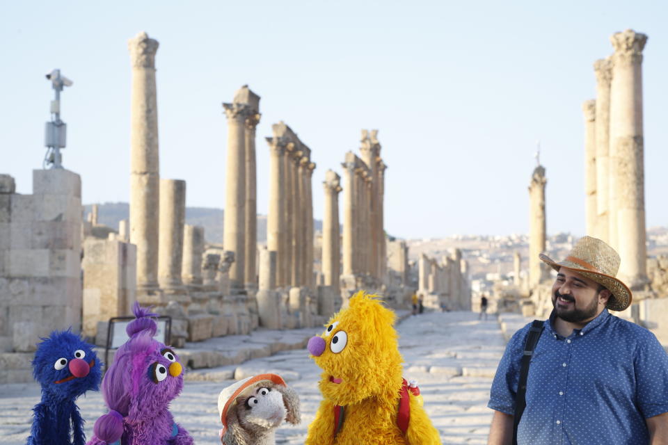 This image released by Sesame Workshop shows, from left, Grover, Basma, Ma'zooza and Jad with Rami Delshad, who portrays Hadi in "Welcome Sesame," a new, locally produced Arabic TV program for the hundreds of thousands of children dealing with displacement in Syria, Iraq, Jordan and Lebanon. (Sesame Workshop via AP)