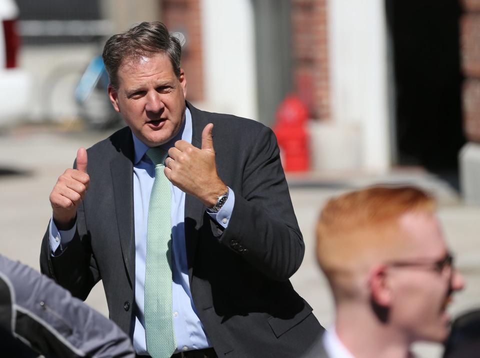 Gov. Chris Sununu is seen as a large crowd gathered on Court Street for the official dedication of Portsmouth affordable housing development named Ruth Lewin Griffin Place Wednesday, June 8, 2022.