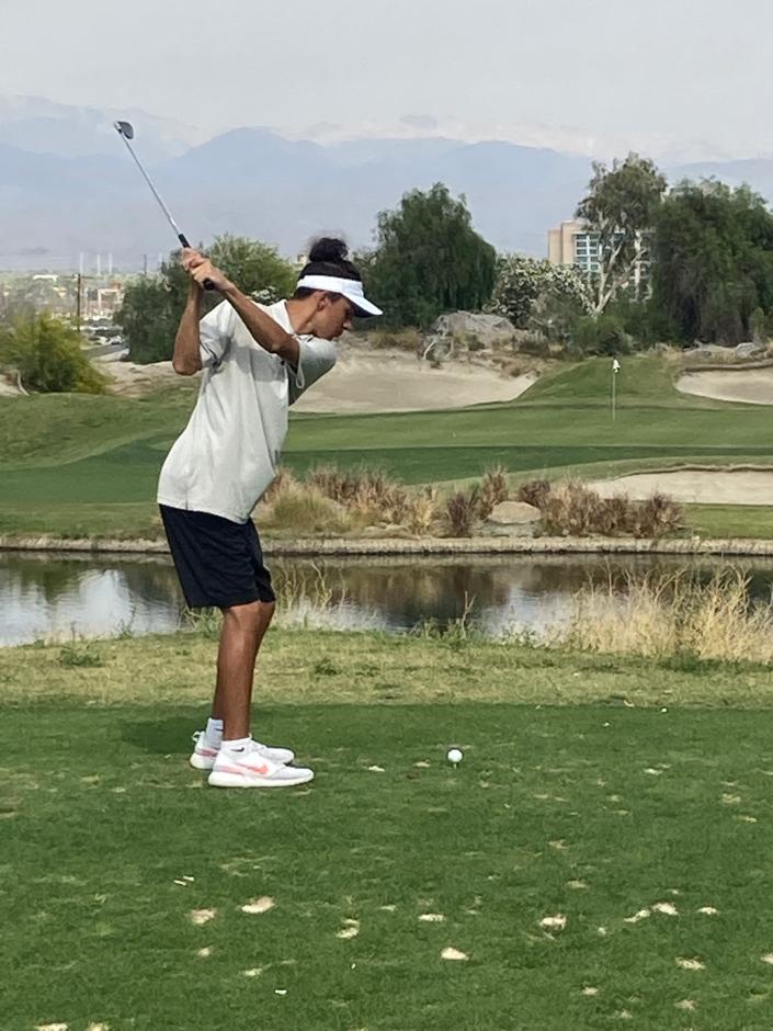Nate Cozad of Rancho Mirage High School tees off on the par-3 fifth hole of the Rattlers&#39; home match Tuesday against La Quinta at the Mission Hills North Course in Rancho Mirage.