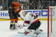 Anaheim Ducks' Derek Grant, left, watches as the puck he shot flies over Ottawa Senators goaltender Anton Forsberg for a goal during the second period of an NHL hockey game Friday, Nov. 26, 2021, in Anaheim , Calif. (AP Photo/Jae C. Hong)