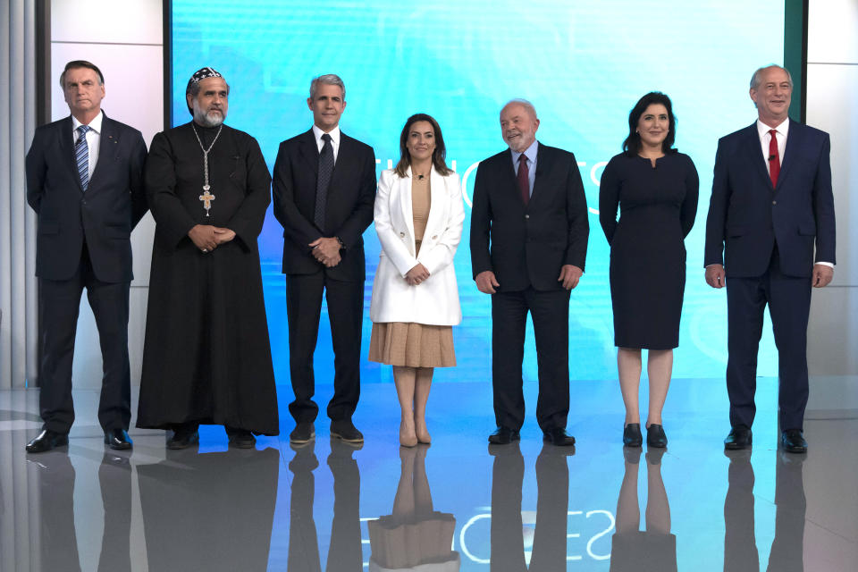 From left, Brazil's President Jair Bolsonaro, who is running for re-election, Padre Kelmon of the Brazilian Labour Party, Felipe D'Avila of the Novo Party, Soraya Thronicke of the Brasil Union Party, former president and now presidential candidate Luiz Inacio "Lula" da Silva of the Workers' Party, Simone Tebet of the Brazilian Democratic Movement Party, and Ciro Gomes of the Democratic Labour Party, arrive to participate in a presidential debate in Rio de Janeiro, Brazil, Thursday, Sept. 29, 2022. Brazil will hold general elections on Oct. 2. (AP Photo/Bruna Prado)