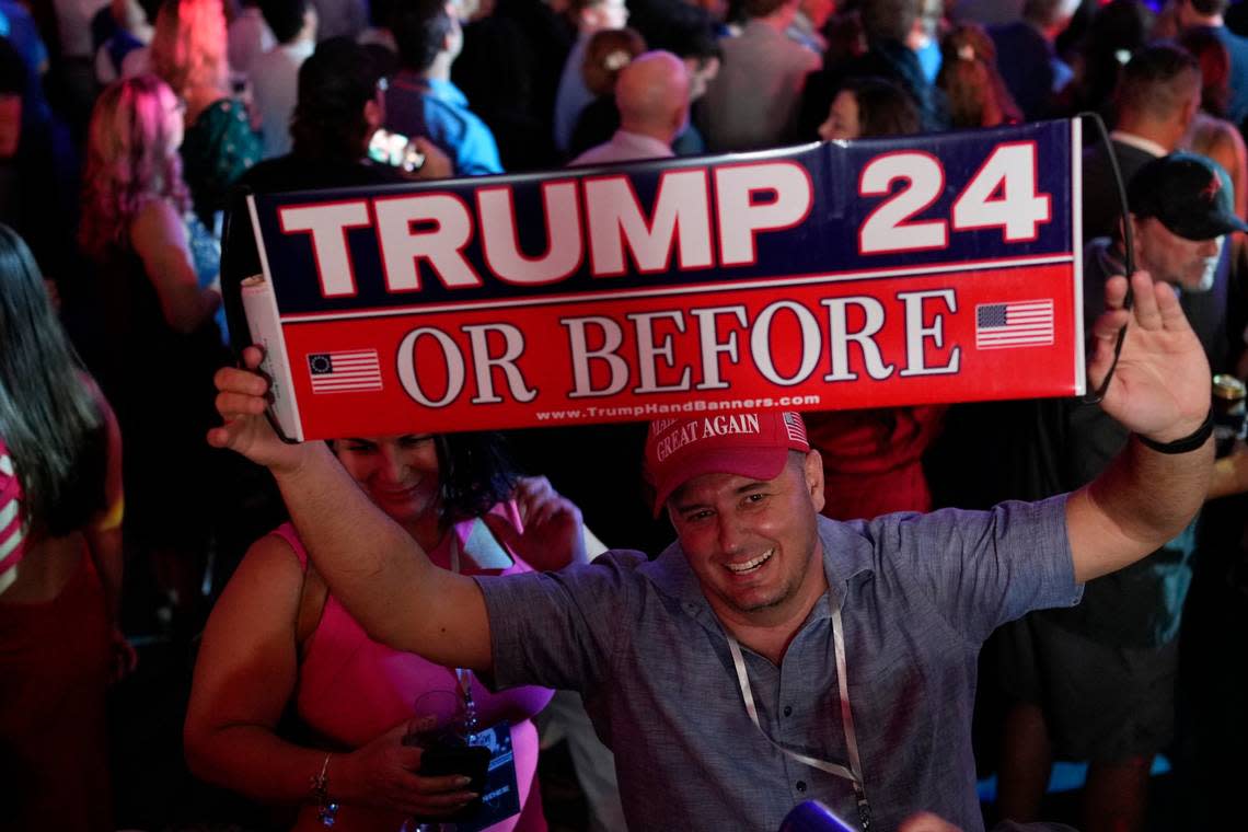 A person holds up a sign before incumbent Florida Republican Gov. Ron DeSantis speaks to supporters during an election night party, in Tampa, Fla., Tuesday, Nov. 8, 2022.