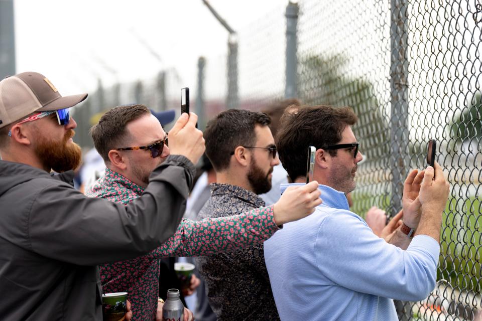 From right, Charlie Igo, Mike Igo, Dave Autry, and David Garscia film a race in the infield at Churchill Downs on Derby Day on Saturday, May 6, 2023, in Louisville, Ky.