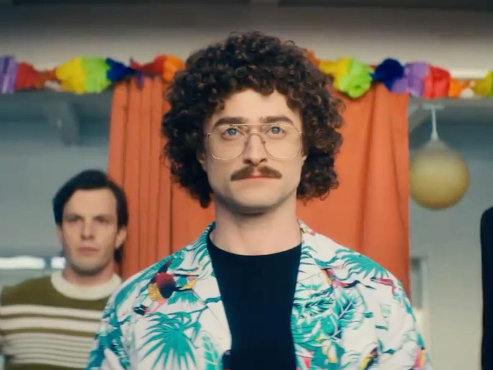 Daniel Radcliffe dressed as his character of 'Weird Al' Yankovic, wearing a wig, glasses and a Hawaiian shirt.