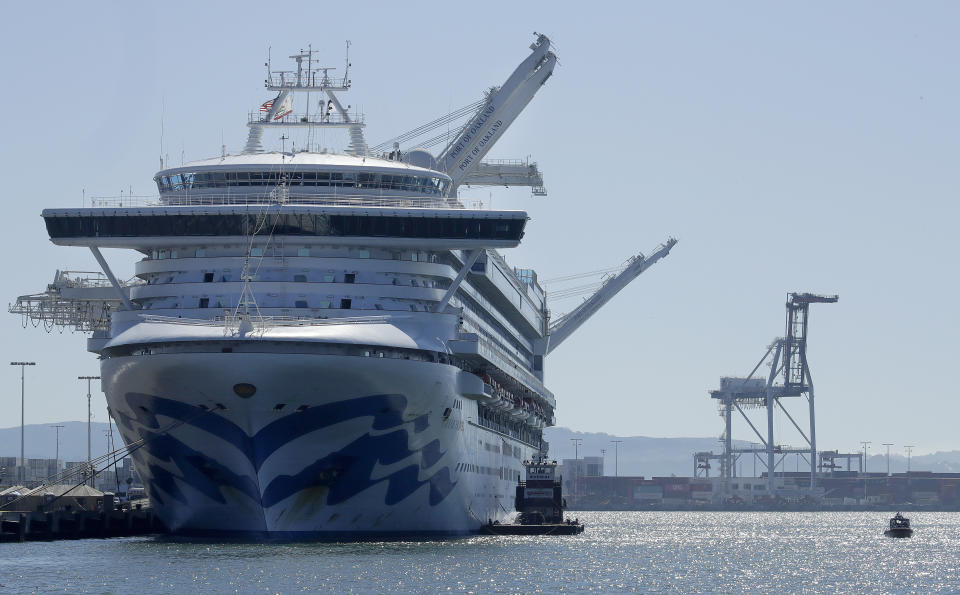 The Grand Princess cruise ship is shown docked at the Port of Oakland Thursday, March 12, 2020, in Oakland, Calif. California Gov. Gavin Newsom says nearly 500 passengers remain aboard the cruise ship. In addition to the 21 people who previously tested positive while aboard, Newsom says at least two more people have tested positive after leaving. For most people, the new coronavirus causes only mild or moderate symptoms. For some it can cause more severe illness. (AP Photo/Ben Margot)