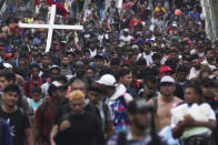 Migrants, many from Central American and Venezuela, walk along the Huehuetan highway in Chiapas state, Mexico, early Tuesday, June 7, 2022. The group left Tapachula on Monday, tired of waiting to normalize their status in a region with little work and still far from their ultimate goal of reaching the United States. (AP Photo/Marco Ugarte)