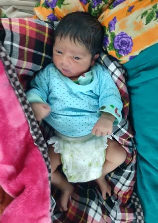 A baby boy is pictured in a hospital two days after his birth for which his parents travelled hours from south Kashmir's Kokernag to reach a Srinagar hospital