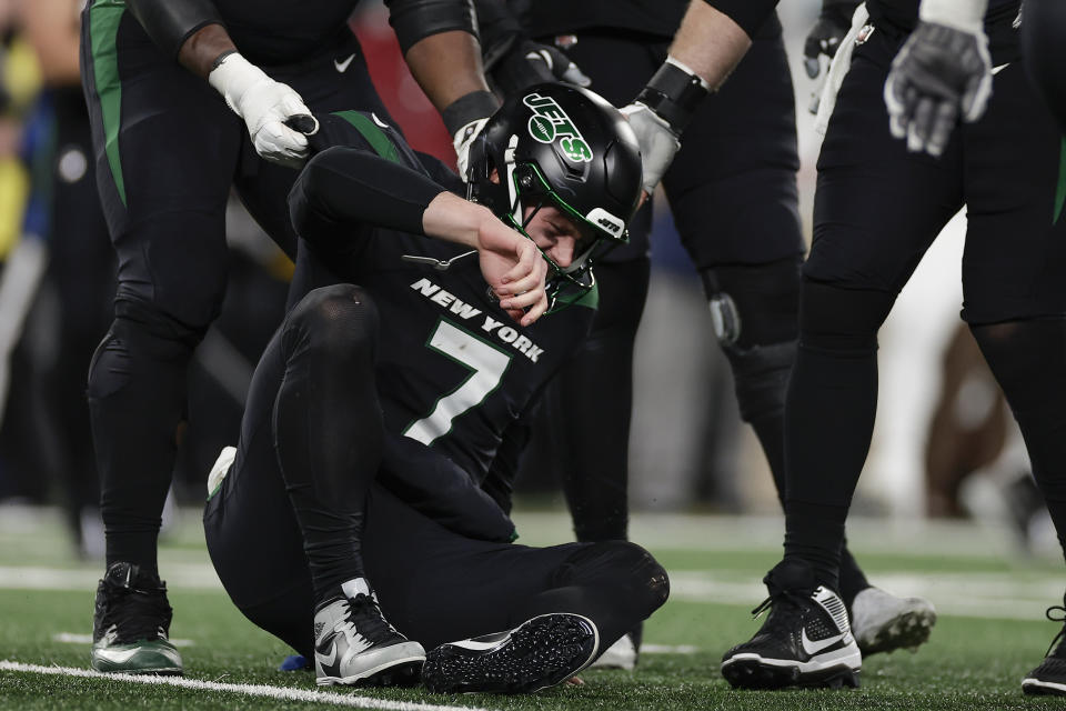 New York Jets quarterback Tim Boyle (7) is helped up off the turn after a sack during the fourth quarter of an NFL football game against the Miami Dolphins, Friday, Nov. 24, 2023, in East Rutherford, N.J. (AP Photo/Adam Hunger)