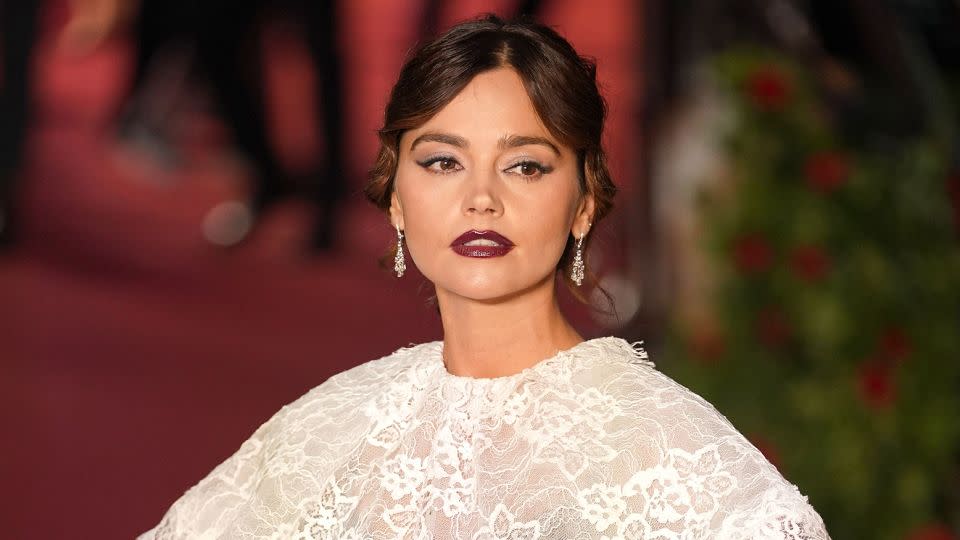 Actress Jenna Coleman wore a silky black dress, from Rodarte’s Fall-Winter 2023 ready-to-wear collection, and a white lace shawl. - Yui Mok - PA Images/Getty Images