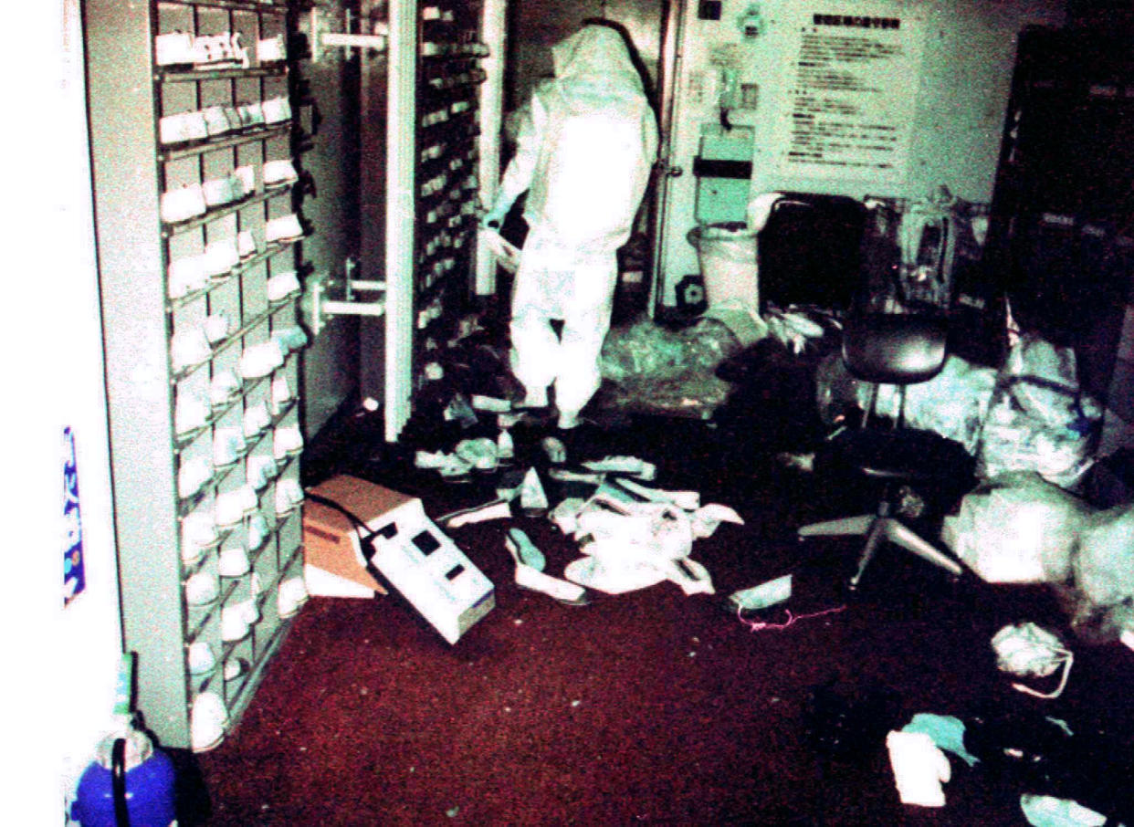 An investigator in protective clothing walks through debris to check the level of radiation after a fire and explosion in a nuclear processing plant in Tokaimura, northern Japan late March 11. Twenty-one workers were contaminated with extremely low level of radiation in the incident but were allowed to go home after medical examinations.   
? QUALITY DOCUMENT