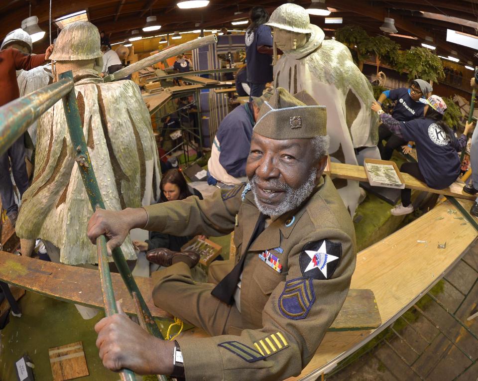 Korean War veteran James McEachin, 82, poses in front of the Rose Parade float “Freedom Is Not Free” by the Korean War Commemoration Committee, Saturday, Dec. 29, 2012, in Pasadena, Calif. McEachin is scheduled to ride the float in the Rose Parade on Tuesday, Jan. 1, 2013. (AP Photo/Mark J. Terrill)