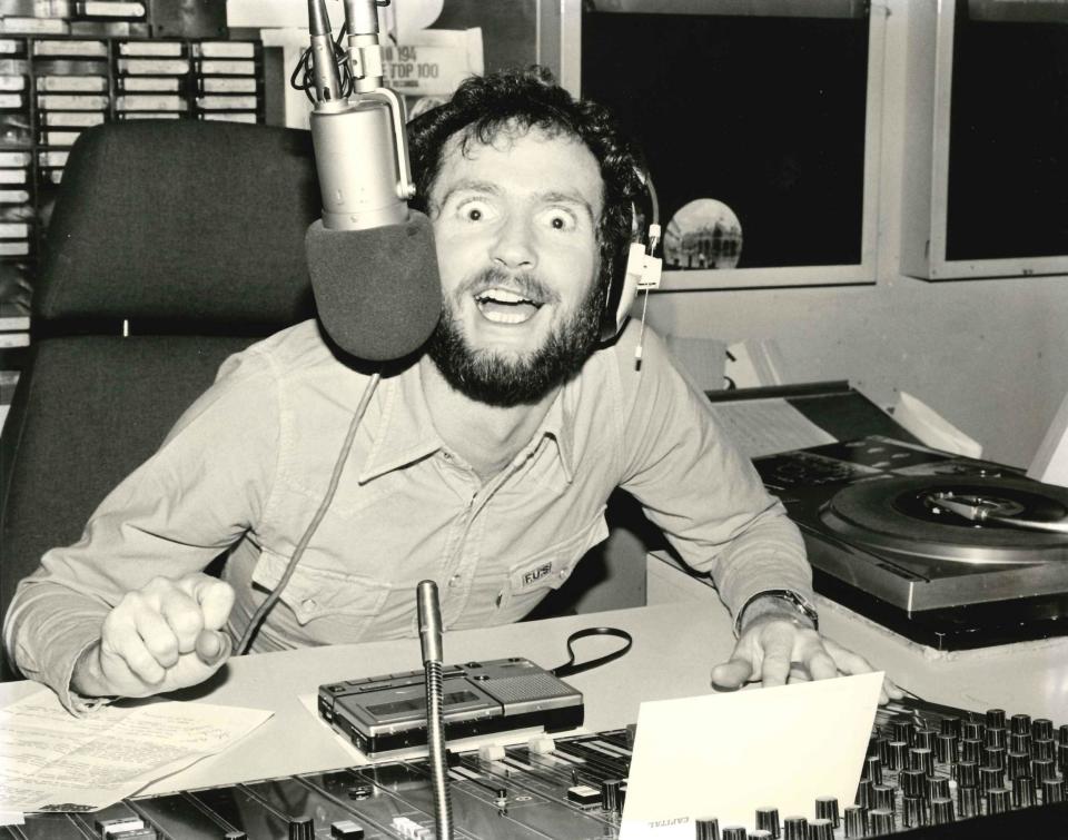 Comedian Kenny Everett, known for his larger-than-life personality sits at his desk in the studio (Leia Clancy, You've Got Three Minutes)