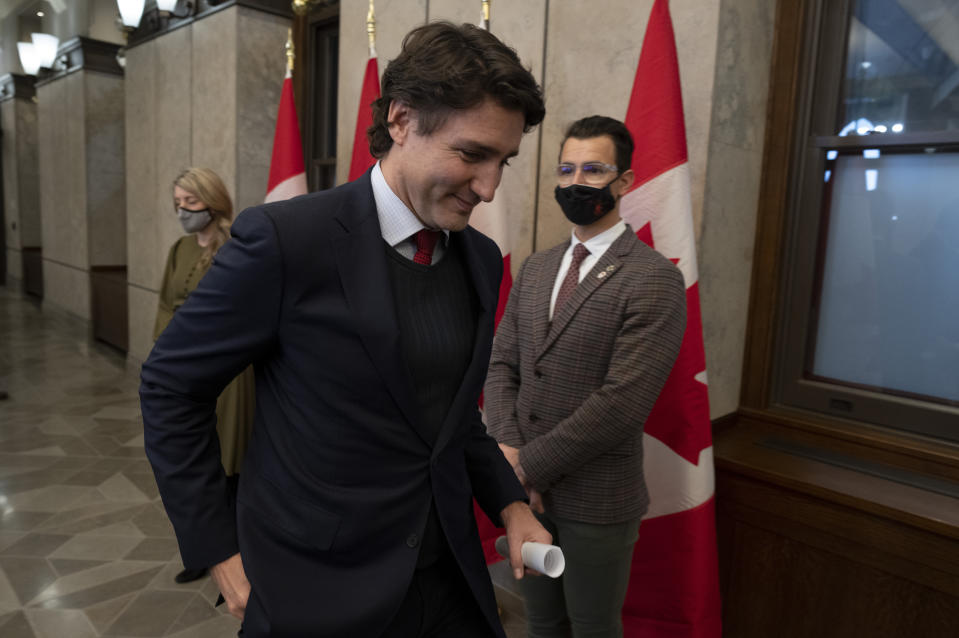 Canadian Prime Minister Justin Trudeau leaves a press conference after announcing Canada will join a diplomatic boycott of the Beijing Winter Olympics over human rights concerns in Ottawa, Ontario, Wednesday, Dec. 8, 2021. At left is Foreign Affairs Minister Melanie Joly. At right is former Olympic athlete and member of parliament Adam van Koeverden. (Adrian Wyld/The Canadian Press via AP)