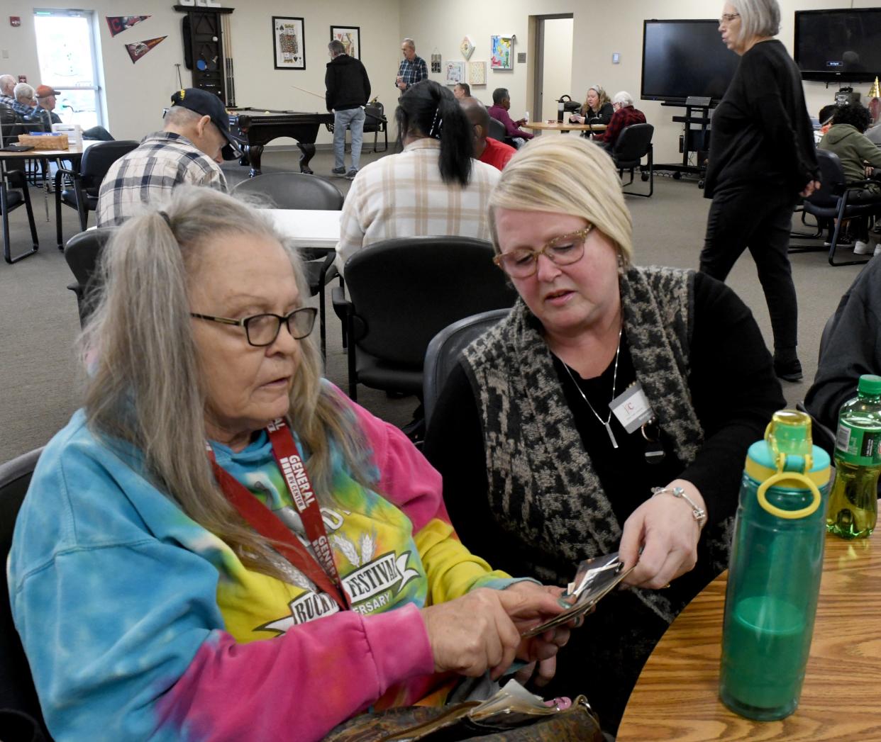 Karen Hartman, a client at JRC Adult Day Center in Canton Township, speaks with the center Director Melanie Griffith.
