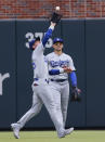 Los Angeles Dodgers center fielder Cody Bellinger catches a fly ball hit by Atlanta Braves' Ronald Acuña Jr., in front of right fielder Trayce Thompson during the first inning of a baseball game Saturday, June 25, 2022, in Atlanta. (AP Photo/Bob Andres)