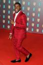 <p>John Boyega brightened up the carpet in a bright red brocade suit.</p>