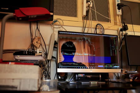 A student looks at stock indexes on his desktop during summer holiday at home in Shanghai, China, in this August 27, 2015 file picture. REUTERS/Aly Song/Files