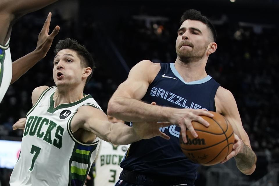 Memphis Grizzlies' John Konchar is fouled by Milwaukee Bucks' Grayson Allen during the second half of an NBA basketball game Wednesday, Jan. 19, 2022, in Milwaukee. (AP Photo/Morry Gash)