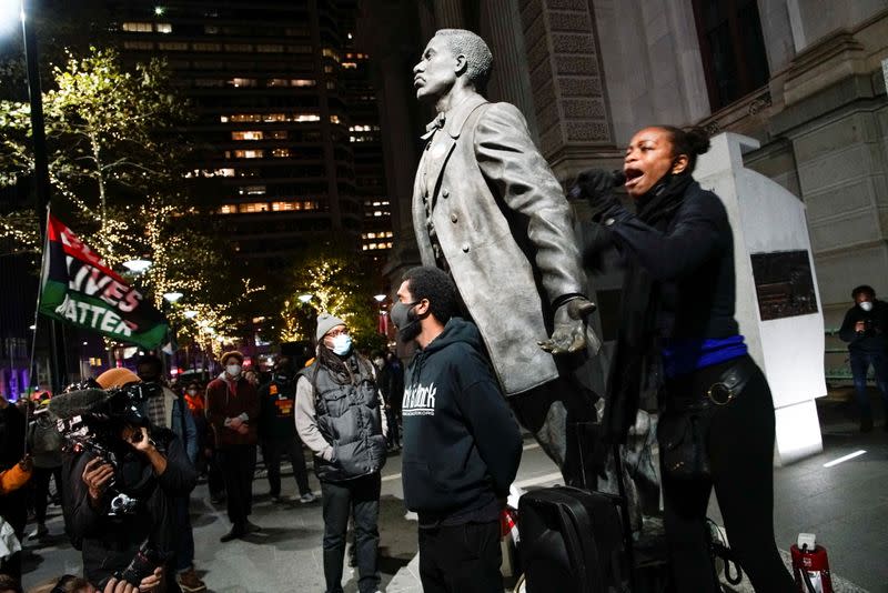 A demonstrator speaks as people gather after a rally demanding a fair count of the votes of the 2020 U.S. presidential election, in Philadelphia