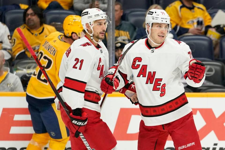 Carolina Hurricanes right wing Jesper Fast (71) celebrates with Nino Niederreiter (21) after Fast scored a goal against the Nashville Predators in the first period of an NHL hockey game Saturday, Oct. 16, 2021, in Nashville, Tenn. (AP Photo/Mark Humphrey)