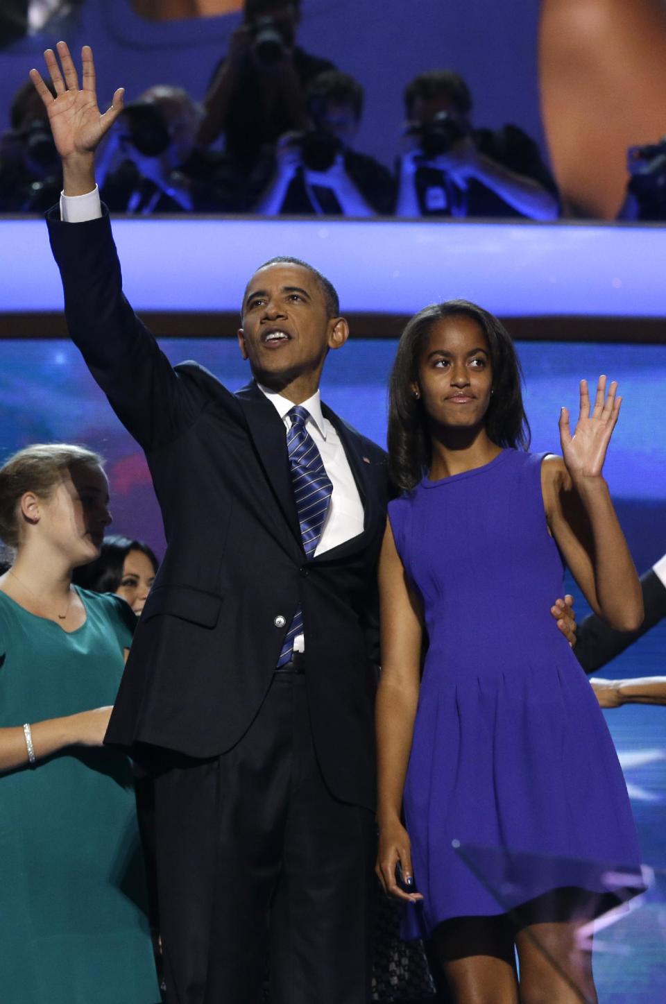 President Barack Obama and his daughter Malia wave after President Obama's speech to the Democratic National Convention in Charlotte, N.C., on Thursday, Sept. 6, 2012. (AP Photo/Charles Dharapak)