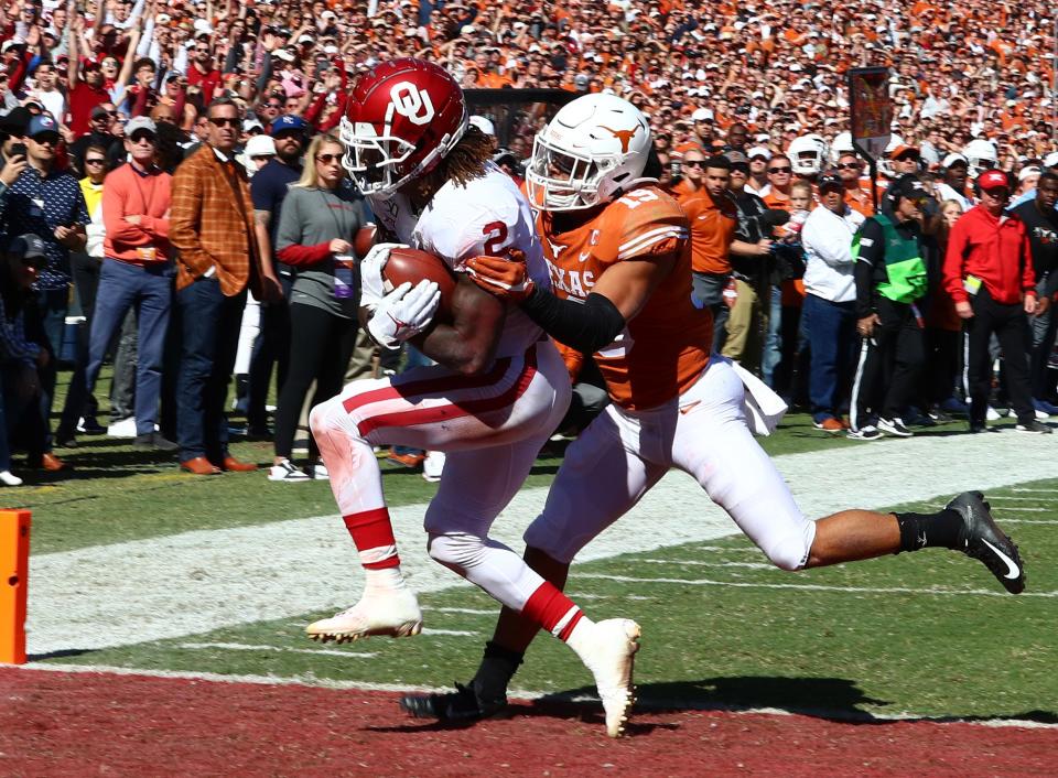 Oklahoma receiver CeeDee Lamb (2) catches a first quarter touchdown pass against Texas' Brandon Jones in their annual Red River Rivalry game in 2019. Both Big 12 schools are on target to join the SEC no later than 2025.