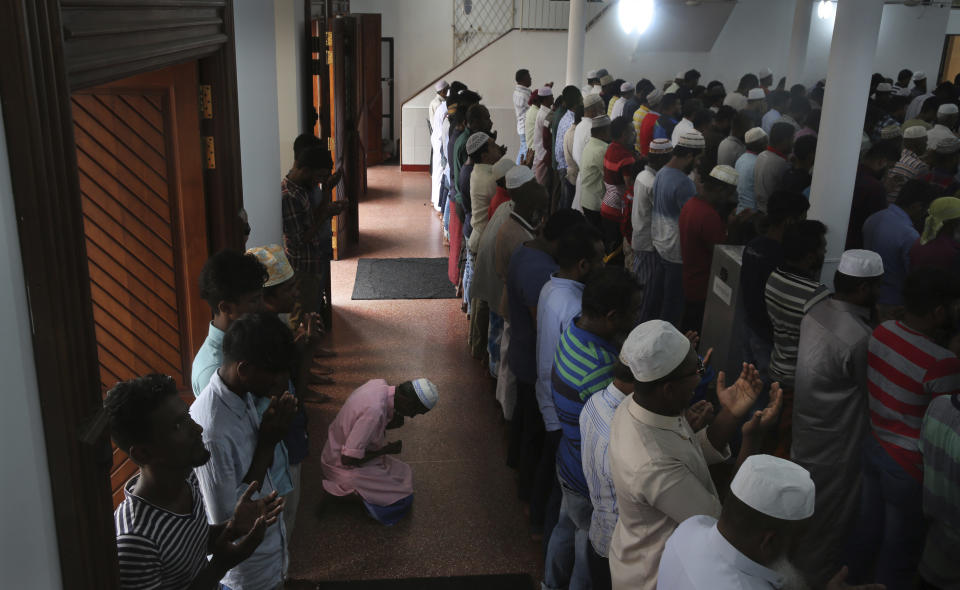 Sri Lankan Muslims offer Friday prayers inside a mosque, in Colombo, Sri Lanka, Friday, April 26, 2019. Across Colombo, there was a visible increase of security as authorities warned of another attack and pursued suspects that could have access to explosives. Authorities had told Muslims to pray at home rather than attend communal Friday prayers that are the most important religious service for the faithful. At one mosque in Colombo where prayers were still held, police armed with Kalashnikov assault rifles stood guard outside. (AP Photo/Manish Swarup)