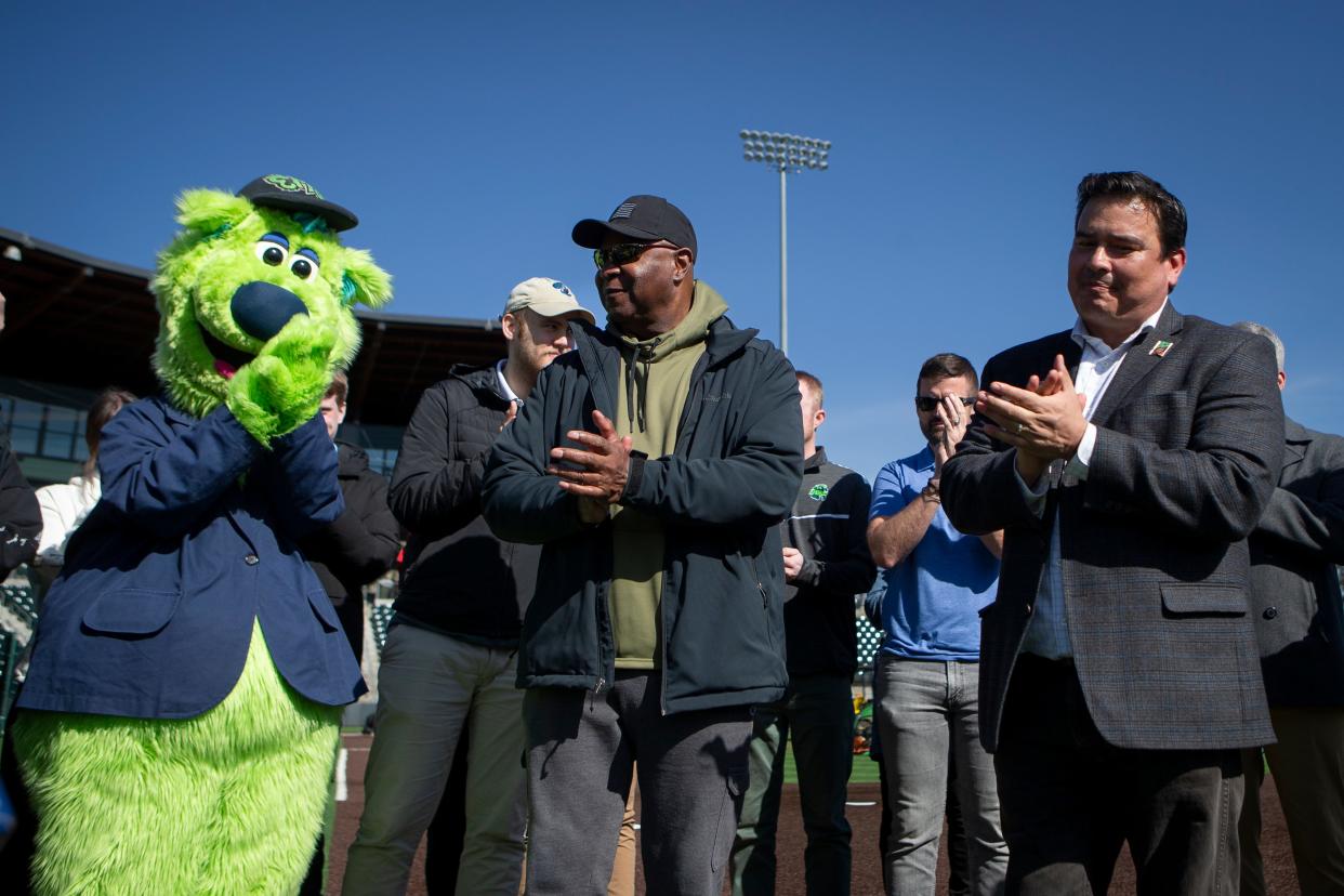 Eugene Emeralds General Manager Allan Benavides, right, Oregon Sen. James Manning Jr. and Sluggo applaud during a March 8 event to discuss funding for a new home for the Eugene Emeralds at PK Park in Eugene.