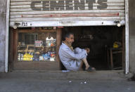 A Kashmiri shopkeeper sits at the entrance of his half closed shop during lockdown in Srinagar, Indian controlled Kashmir, July 27, 2020. Indian-controlled Kashmir's economy is yet to recover from a colossal loss a year after New Delhi scrapped the disputed region's autonomous status and divided it into two federally governed territories. (AP Photo/Mukhtar Khan)