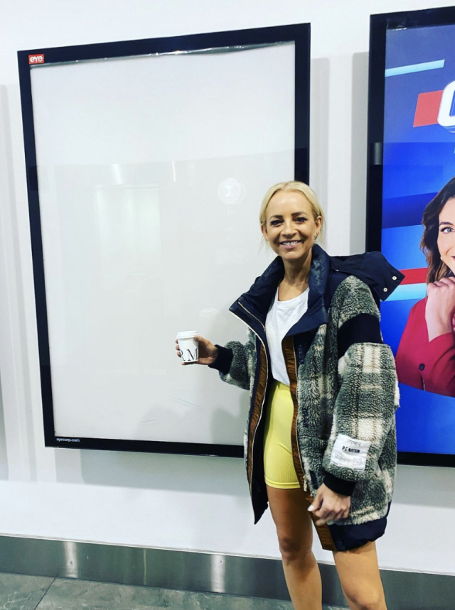 Carrie Bickmore poses in activewear next to an empty frame. 