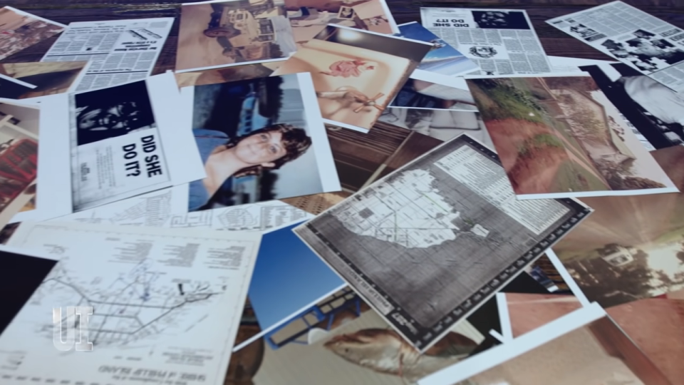 Newspaper clippings, photos, and maps strewn across a table