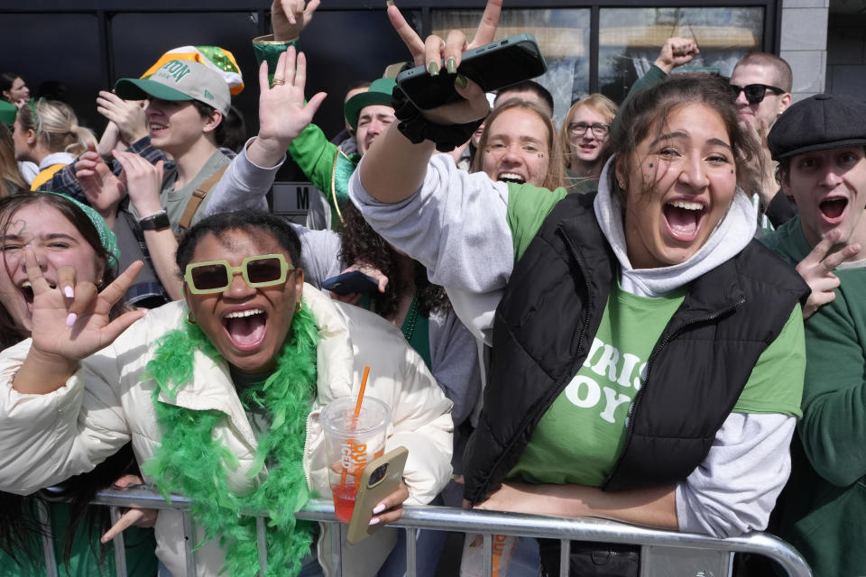 Spectators cheer while watching the St. Patrick's Day parade, Sunday, March 17, 2024, in Boston's South Boston neighborhood. (AP Photo/Steven Senne)